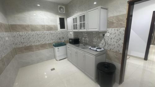a small kitchen with a sink and a counter at أرياف سويت in Al Baha