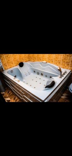 a bath tub with a faucet and a sink at Mo Exortic Royale Services in Ikorodu