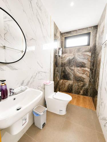 a bathroom with a sink and a toilet and a mirror at X2 privacy villa in Khon Kaen