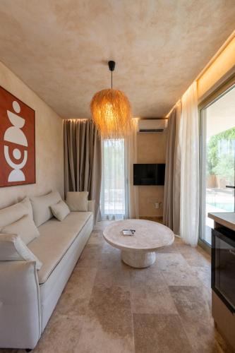 a living room with a couch and a table at Terra Elea Luxury Pool Suite Aura in Nikiti