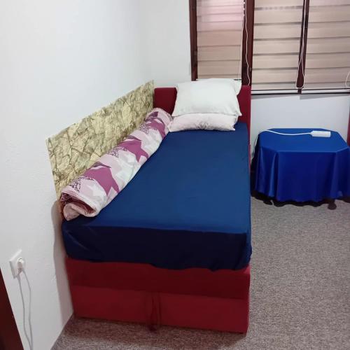 a bed in the corner of a room at Kuca za prespavati in Bihać