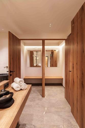 a bathroom with a counter with towels on it at Hotel Pongauerhof in Flachau