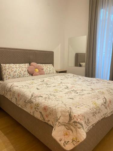 a bedroom with a bed with a stuffed animal on it at BIJELA apartman 2025 in Bijela