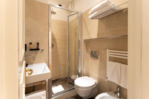 a bathroom with a toilet and a sink and a shower at La Villa in Siena