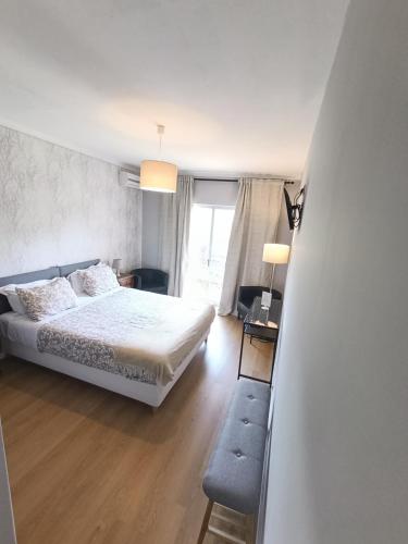 a bedroom with a white bed and a window at Residencial Do Rita em Rio Caldo in Geres
