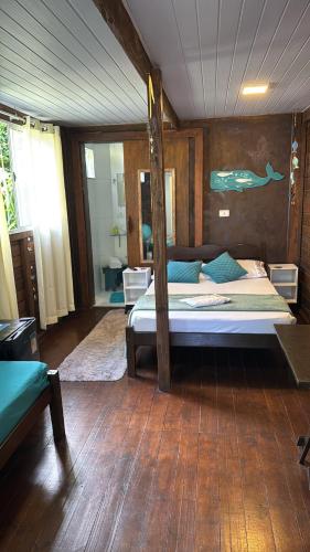 a bedroom with a bed with a pole in it at Recanto do Sol II in Ilha do Mel