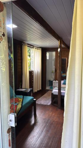 a room with a bedroom with a bed and a mirror at Recanto do Sol II in Ilha do Mel