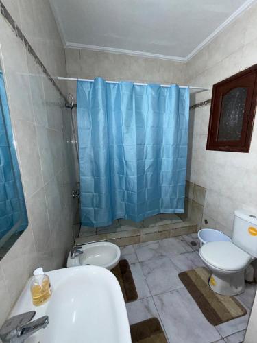 a bathroom with a toilet and a sink and a shower at Samadis Home 3 in Larache