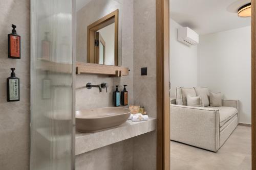 a bathroom with a sink and a mirror at Karavel Suites - Old Town Boutique Rooms in Rhodes Town