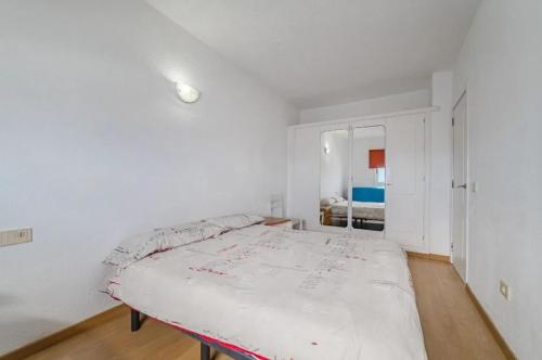a white bedroom with a large bed in it at oceano de bajamar in Bajamar