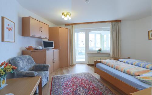 a living room with a couch and a chair at Düne, App 12 in Duhnen