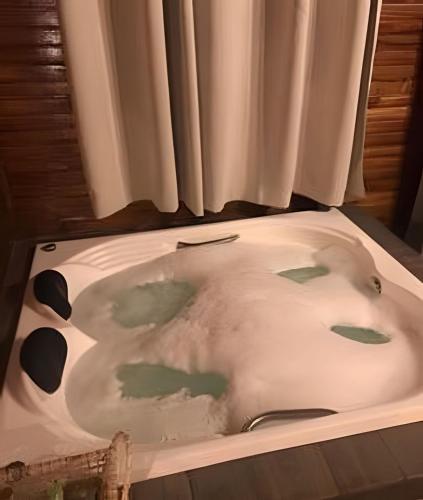 a bath tub with a cow print on it at Cabana surucuã in Três Coroas