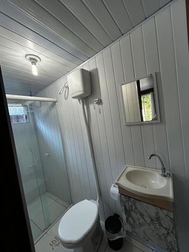 a bathroom with a toilet and a sink and a shower at Recanto do Sol I in Ilha do Mel
