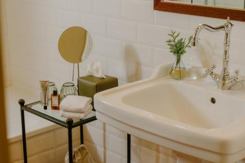 a bathroom with a sink and a mirror at Hotel Bremon by Grup Duquessa in Cardona