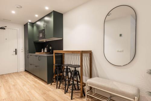 a kitchen with a table and a mirror at Cauce 4 Apartments in Torremolinos