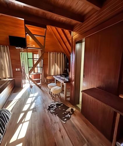 a bedroom with a desk and a bed in a room at Cabana Andorinha in Três Coroas