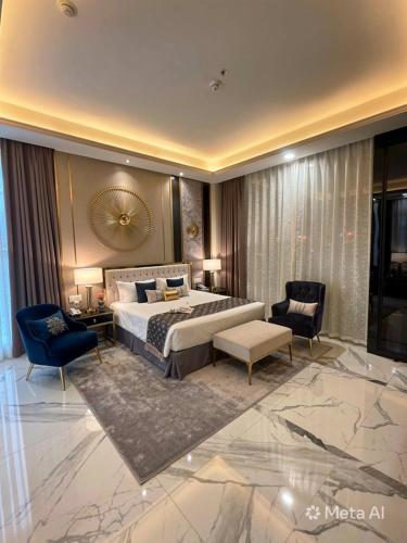 a hotel room with a bed and a couch and chairs at Hotel Galaxy international Delhi igi Airport Free pickup in Ghaziabad