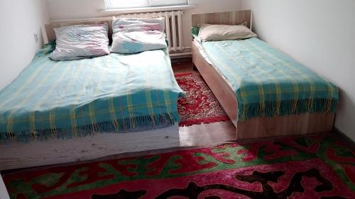 two beds sitting next to each other in a room at House Ali in Klyuchi