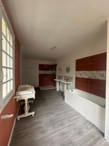 a large bathroom with a sink and a tub at Manoir du Moulin Fleury in Villedieu-les-Poêles