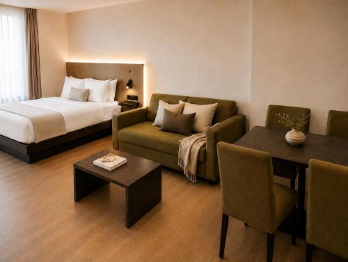 a hotel room with a bed and a couch and a table at SleepySleepy Hotel Fulda in Fulda
