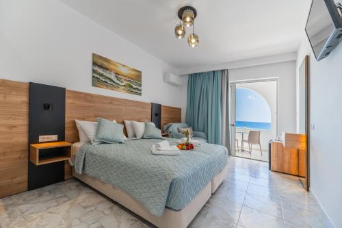 a bedroom with a bed with a view of the ocean at Haraki Bay Hotel and Luxury Apartments in Haraki