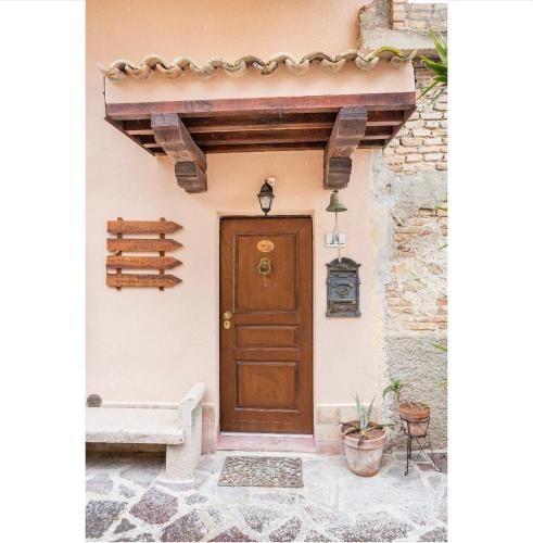a door of a house with a bench next to it at Zanna Casa Vacanza a soli 450 mt dal mare in Grottammare