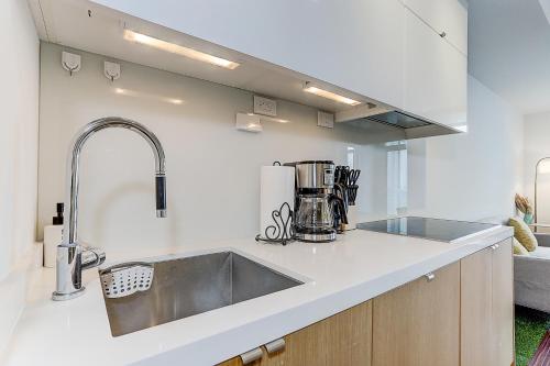 a kitchen with a sink and a counter top at Lakeview 1 Bed 1 Den by Rogers Centre in Toronto