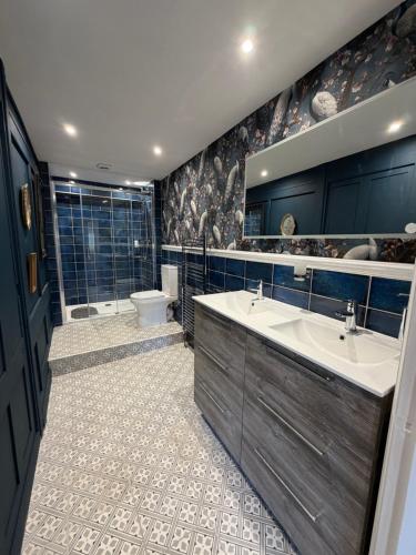 a bathroom with two sinks and a toilet at Kip 54 Monks Bar in Portsmouth
