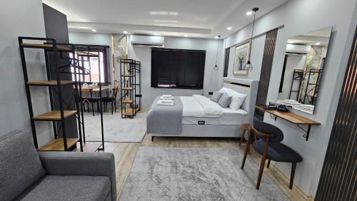 a bedroom with a bed and a table and chairs at Dereboyu Premium in Nicosia