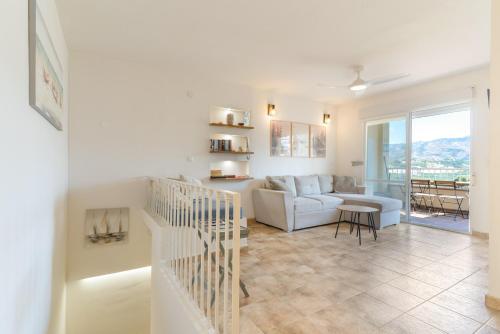a living room with a couch and a table at Bellavista Los Pinos in Almuñécar