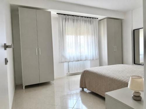 a bedroom with a bed and a large window at Emy Dreams in Citta' Sant'Angelo