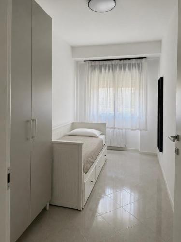 a white bedroom with a bed and a window at Emy Dreams in Citta' Sant'Angelo