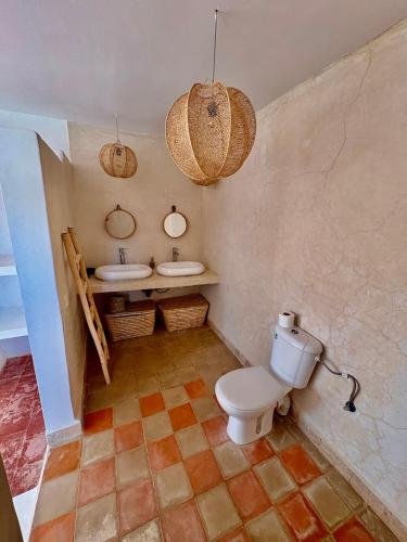 a bathroom with a toilet and a sink at Chez les copains in Sidi Kaouki
