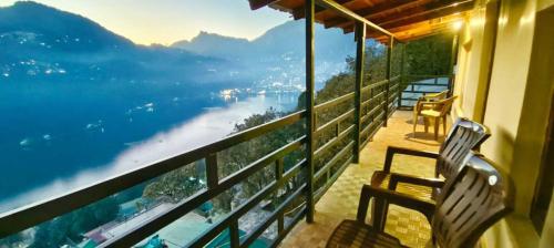 a balcony with a bench and a view of the water at The Lake BnB in Nainital
