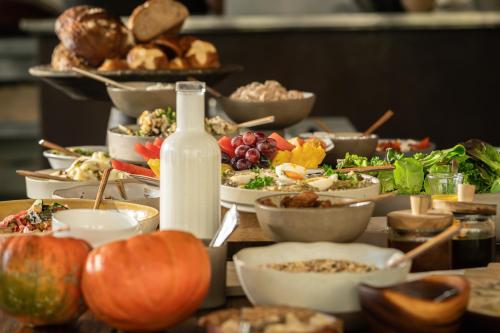 a table topped with plates of food and a bottle of milk at Pereh Mountain Resort in Gadot