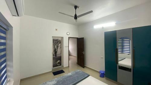 a living room with a couch and a ceiling fan at Future homes in Kunnamkulam
