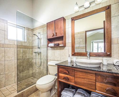 a bathroom with a sink and a toilet and a shower at Ocean Dream - Kite Paradise! in Cabarete