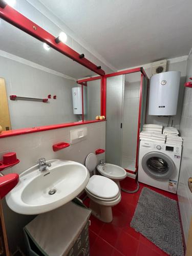 a bathroom with a sink and a washing machine at Cervinia Mountain View Apartments in Breuil-Cervinia