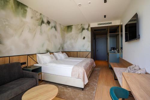 a hotel room with a bed and a couch at Degenija Boutique hotel & Spa in Seliste Dreznicko