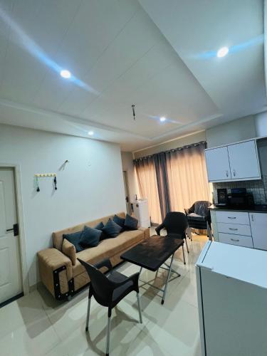 a living room with a couch and a table and chairs at Royal Stays 2Bed Cozy Apartment in Multan
