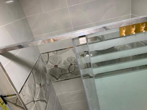 a glass shelf in a bathroom with flowers on it at Studio in Porto Said Compound in Port Said
