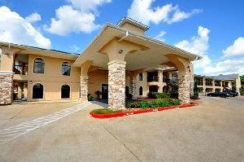 a large building with a parking lot at Clarion Pointe in Huntsville