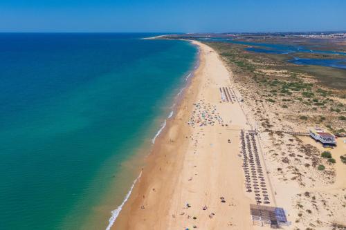 an aerial view of a beach with people on it at Kampaoh Tavira in Tavira
