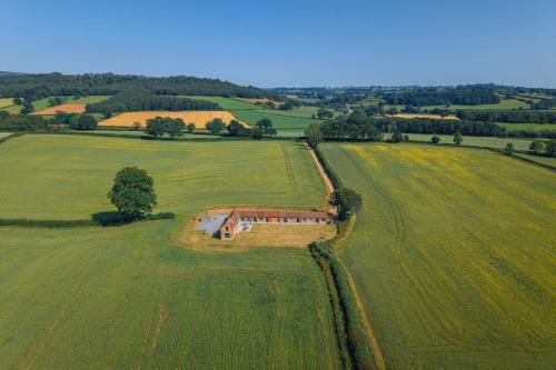 an aerial view of a house in the middle of a field at Scenic Barn Conversion in Rural Shropshire in Craven Arms