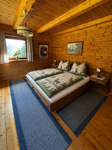a bedroom with a bed in a log cabin at Almhütte Astental in Vordere Asten