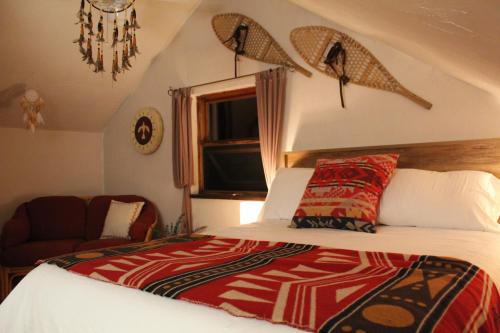 a bedroom with a bed with surfboards on the wall at Slo-Brome gîte de charme slow life in Lac-Brome