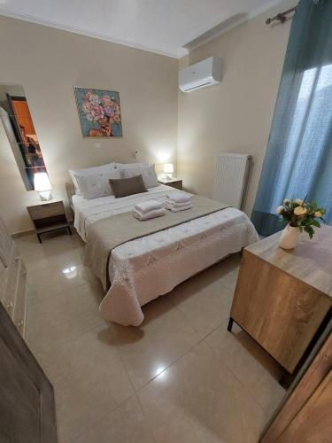 a bedroom with a large bed with two nightstands and two tables at The Mastiha Spot 5 in Chios