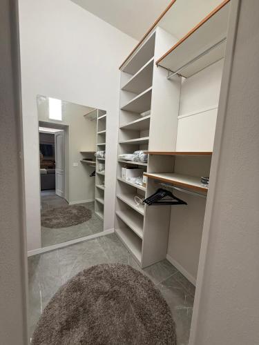 a walk in closet with white cabinets and a rug at Il campanile in Corbetta