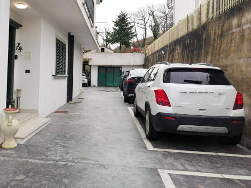 a row of parked cars parked next to a building at B&B TENUTA BIANCA in Oliveto Citra