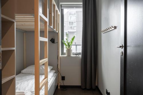 a small room with a bunk bed and a window at View Apartments in Åre
